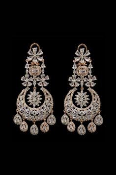 Fadia Kundan Earrings With their stunning cascading silhouette these pair of earrings will inject an extra dose of glamour to your look.  Exquisite chandelier earrings with high-quality CZ stones Approximately earrings size is 4.25 .  Silver-plated on high-quality brass as the base metal. Details: Handcrafted Metal: Silver Plated Stone: CZ stones Dimensions: Length 4.25 inches  Chandelier Earrings Elegant Hand Set Chandbali Hoop Earrings, Elegant Chandbali Hoop Earrings Hand Set, Elegant Chandbali Cubic Zirconia Earrings, Glamorous Hand Set Dangle Bridal Earrings, Elegant Danglers For Reception, Hand Set Diamond Teardrop Bridal Earrings, Dazzling Diamond White Chandelier Earrings, Glamorous Hand Set Diamond Bridal Earrings, Elegant Dangle Chandbalis For Wedding