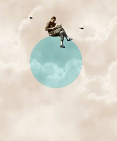 a man sitting on top of a blue circle in the sky with birds flying around