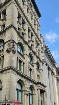 an old building with many windows on the corner