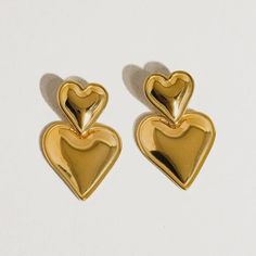 These layered hear earrings make heart earrings modern. This pairing of gold drop earrings features a simple stud connected to an elegant gold heart drop. We love this style for date night, girls' night, or really any night, as a matter of fact. 18k gold plated stainless steel Measurement (L x W inch): 1.2 x 0.8 Post back closure Tarnish free Style For Date, Cardigan Sweater Dress, Modern Earrings, Gold Drop Earrings, Gold Heart, Heart Of Gold, Heart Earrings, Girls Night, Shop Earrings