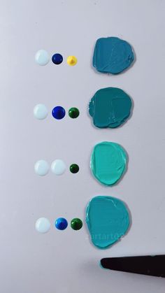 several different colors of paint being used on a white surface