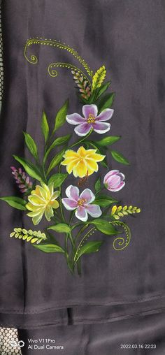 a painting of flowers and leaves on a black cloth with green stems in the center