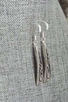 These sterling silver earrings were made by Hopi silversmith Augustine Mowa. The back is stamped sterling.Length: 1 1/2"Width: 3/8"Free shipping on all orders! We ship with USPS and always include tracking. All orders ship within a day of payment.Returns are accepted up to 30 days after you receive your order. Just send us a message. Our shop offers cash back or store credit. The item must be returned in new condition. Engraved Sterling Silver Drop Earrings, Engraved Sterling Silver Dangle Jewelry, Engraved Teardrop Sterling Silver Earrings, Artisan Long Drop Sterling Silver Earrings, Classic Engraved Sterling Silver Earrings, Artisan Silver Long Drop Earrings, Artisan Long Drop Silver Earrings, Silver Engraved Teardrop Earrings, Silver Symbolic Engraved Earrings