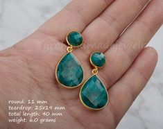 This pair of two tier genuine gemstone (emerald) earrings would be a great reward for your self or a great gift for your mother or best friend. Each one has two tiers of natural stones:1. top tier: a small (11mm) round emerald in gold bezel2. bottom tier: a large pear shaped emerald (natural gemstone) stone (about 25 x 19 mm) set in gold bezel    Note: other stone combinations available. Please inquire.3. earring total length ~ 40 mm4. bezel material: 24k gold plated5. earring wire: 24k gold pla Green Round Faceted Earrings, Green Faceted Round Earrings, Fine Jewelry Green Drop Earrings, Green Fine Jewelry Drop Earrings, Elegant Green Emerald Earrings, Green Emerald Teardrop Earrings, Green Emerald Earrings For Anniversary, Green Faceted Earrings For Anniversary, Formal Emerald Earrings With Birthstone