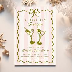 a pink and green christmas card with two martini glasses