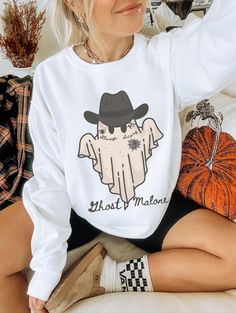 Show off your cowghoul aesthetic in our spooky Ghost Malone shirt. This trendy Halloween sweatshirt is slightly disressed and oversized, perfect for a cozy fall outfit. * Ultra soft * Distressed design * Pre-shrunk * Universal fit * True to size * DTG Printing * Brand - Gildan Refunds/Exchanges: * No Cancellations * No returns/exchanges * All sales are final Sizing: Our graphic tees and sweatshirts are a true to size standard unisex fit. For an oversized look, please size up. For a TShirt dress Oversized Graphic Sweater Outfit, Horror Long Sleeve T-shirt For Fall, White Band Merch Tops For Fall, White Band Merch Top For Fall, White Band Merch Sweatshirt For Fall, Horror Crew Neck Tops For Fall, Graphic Sweater Outfit, Oversized Graphic Sweater, Monster Sweater