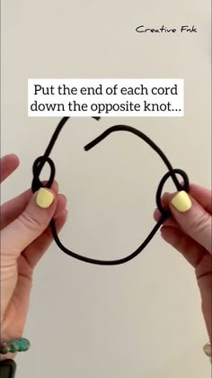 two hands holding black string with white dots on it and the words, put the end of each cord down the opposite knot