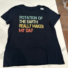 a black t - shirt that says rotation of the earth really makes my day