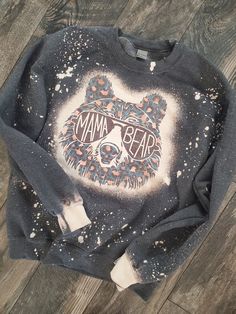 a sweatshirt with the words mama bear painted on it and a skull in the middle