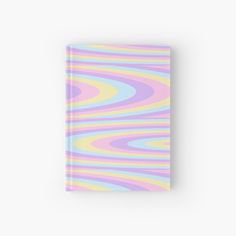 a pink, yellow and blue book with an abstract pattern on the front cover is shown