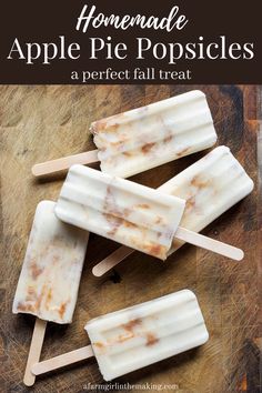 homemade apple pie popsicles on a cutting board with text overlay that reads homemade apple pie popsicles a perfect fall treat