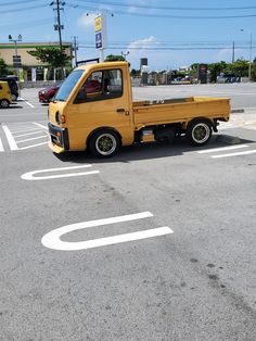 a yellow truck parked in a parking lot