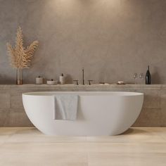 a large white bath tub sitting next to a sink