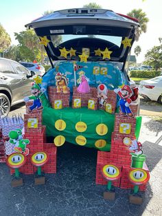 the trunk of a car is decorated with mario and luigi's birthday decorations on it