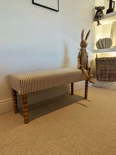 a rabbit sitting on top of a wooden bench