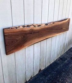 a piece of wood sitting on the side of a building