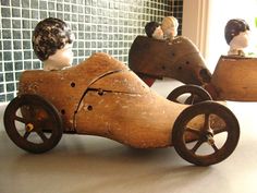 three wooden toy cars sitting on top of a table