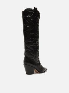 Black leather boot. The style features a mid-shaft, a low stacked block heel, and a pointed toe. It has a western embroidery on the sides of the vamp. There’s no closure and includes a pull-tab on the side of the shaft, making it easy to put on. Why follow this trend? The western boot, also known as cowboy boot, is one of the major trends of the season. Edgy and impressive, it guarantees comfortable and stylish looks. A must-have item of the season, so go for it! Heel Height: 2.8' Outsole Materi Western Embroidery, Western Boot, Cowboy Boot, Leather Boot, Must Have Items, The Vamps, Black Leather Boots, Pull Tab, Western Boots