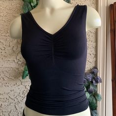 Small Black Sleeveless Top Helps Smooth Out Under Your Clothes Fitted Camisole With Built-in Bra For Relaxation, Fitted Tops With Built-in Bra For Relaxation, Black Tank Top With Built-in Bra For Loungewear, Black Sleeveless Camisole For Workout, Seamless Black Tank Top For Loungewear, Black Shapewear Top For Workout, Bra Friendly Sleeveless Tank Top For Relaxation, Sleeveless Bra Friendly Tank Top For Relaxation, Black Shaping Tops With Built-in Bra