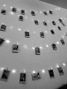 black and white photo hanging on the wall with string lights strung across it's sides