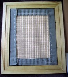 a wooden frame with a piece of cloth on it and some tape around the edges