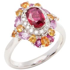 This ring designed by David Jerome is from his private collection and features one oval cut Ruby sourced in Mozambique. Set with a mix of round brilliant cut Diamonds, pink and yellow Sapphires totalling 1.70cts combined. Mounted in platinum. Ring size UK N, EU size 54, USA size 6 1/2. David prides himself in only sourcing the finest and most exclusive gemstones whose natural beauty and colour enhance the settings he creates for each piece. These exclusive designs offer buyers a unique opportuni Sapphire Cluster Ring, Vintage Cluster Ring, Contemporary Ring, Diamond Jewelry Designs, Platinum Ring, Ruby Diamond, Pretty Rings, Pink And Yellow, Yellow Sapphire