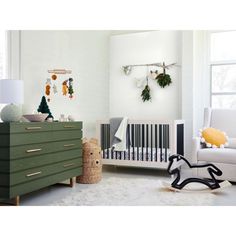 a baby's room with white walls and green dressers in the foreground