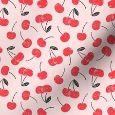 a white background with red cherries and black leaves on it's surface,