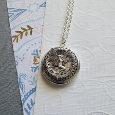 Fairy Gateway Locket Necklace ☻Locket ~ Round Silver ~ With Magical Fairy ~ See Photos for size comparison against American quarter Chain: ~ Silver Plated YOU CHOOSE YOUR CHAIN LENGTH during checkout ☻More Lockets Here: https://www.etsy.com/shop/FashionCrashJewelry/search?search_query=lockets&order=date_desc&view_type=gallery&ref=shop_search ☻Link to The ENTIRE SHOP: https://www.etsy.com/shop/FashionCrashJewelry?ref=shopsection_shophome_leftnav&ga_search_query=crystal%2Bnecklace Fairycore Metal Necklaces As Gift, Fairycore Metal Necklaces For Gift, Fairycore Style Metal Necklaces For Gifts, Fairy Style Adjustable Wedding Jewelry, Adjustable Silver Fairycore Jewelry, Handmade Adjustable Fairy Jewelry, Fairy Style Adjustable Jewelry For Gifts, Fairy Style Silver Jewelry For Gift, Fairycore Silver Jewelry Gift