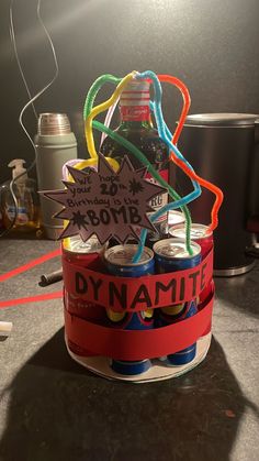 a bunch of soda cans are stacked on top of each other with the words dynamite written on them