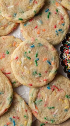 there are many cookies with sprinkles on the table