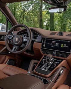 the interior of a luxury car with brown leather seats and dashboards, along with other vehicles