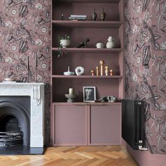 an image of a living room with pink wallpaper and fireplace in the corner, which is also decorated by graham & brown