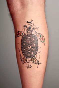 a man with a tattoo on his leg that has a turtle in the middle of it