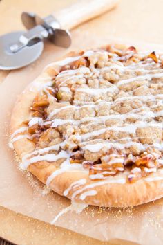 an uncooked pizza sitting on top of a wooden cutting board