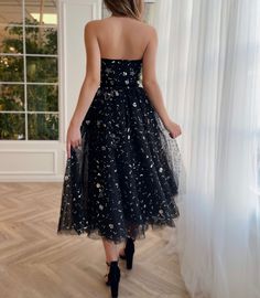 Timeless chic silhouette is adorned with a thousand stars in a dazzling midi dress. Its pointed strapless neckline highlights your décolletage beautifully & its ribbon belt hugs your waist beautifully. Cosmic Dress, Celestial Style, Teuta Matoshi, Timeless Chic, Strapless Neckline, Ribbon Belt, Black Midi, Star Dress, Black Midi Dress