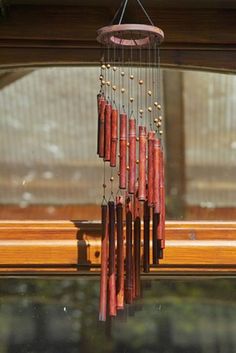 a wind chime hanging from the side of a window