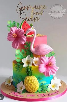 there is a cake decorated with flowers and a flamingo