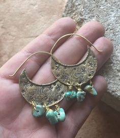 "Swoon! These ooak shield hoops have been hand fabricated using solid brass. These hoops have been heavily textured and stamped with various shapes and tiny stars. Mashan turquoise beads dance along the bottom of these earrings, giving them so much movement! Hammered brass ear wires have been soldered to the tops. Lightweight on the ears. Ready to ship! Xo MATERIALS: Brass, brass wire & Mashan Turquoise beads MEASUREMENTS: Approx 2\" L x 1 1/4\" W These will arrive gift wrapped in an eco friendl Hammered Bronze Jewelry For Festivals, Adjustable Bohemian Patina Earrings, Unique Handmade Turquoise Hoop Earrings, Gold Bohemian Earrings With Patina, Bohemian Turquoise Hoop Earrings Nickel Free, Bohemian Gold Earrings With Patina, Hand Forged Bohemian Hoop Jewelry, Bohemian Hand Forged Hoop Jewelry, Rustic Handmade Hoop Earrings