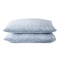 two blue pillows sitting on top of each other