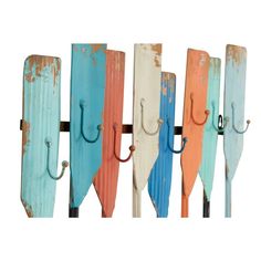 an assortment of different colored umbrellas hanging on a wall with hooks attached to them