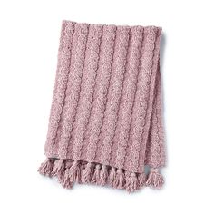 a pink blanket with fringes on it