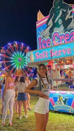 a woman standing in front of an ice cream cart at the fair with other people