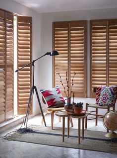 a living room with wooden shutters on the windows