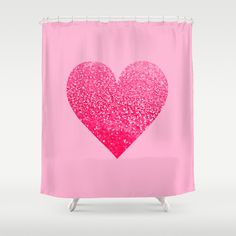 a pink shower curtain with a heart on it