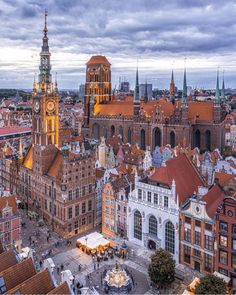 an aerial view of the city with tall buildings and a clock tower in the center