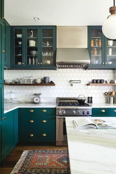 a kitchen with green cabinets and white tile backsplash, an instagram from instagram com