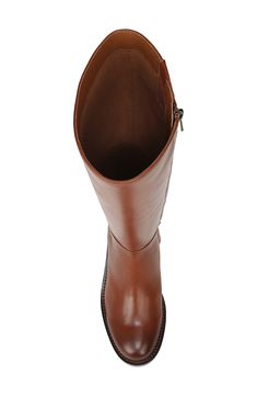 Signature logo hardware enriches the heel counter of a knee-high leather boot balanced by a plain toe and stacked block heel. 1 3/4" heel; 1/2" platform; 15 1/2" shaft; 15 1/2" calf circumference (size 8.5) Leather upper/synthetic lining and sole Imported Brown Knee-high Boots With Round Toe For Business, Brown Wide Calf Heeled Boots For Business, Classic Brown Wide Calf Heeled Boots, Brown Wide Calf Boots For Business, Brown Wide Calf Boots For Office, Leather Tall Platform Boots With Stacked Heel, Brown Leather High Shaft Heeled Boots, Brown Knee-high Office Boots, Brown High Shaft Heeled Boots For Wide Calves