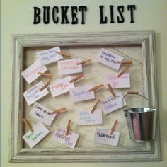 a bulletin board with clothes pins attached to it and the words bucket list written on them