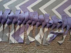 several pieces of purple and white fabric on the floor